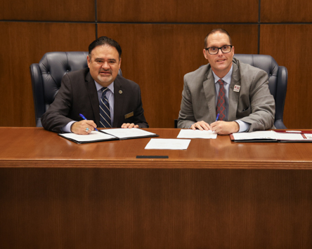 Tyler Junior College President Dr. Juan E. Mejia (left) and A&M-Texarkana President Dr. Ross Alexander sign documents establishing academic pathways for TJC graduates to complete a bachelor’s degree at A&M-Texarkana.