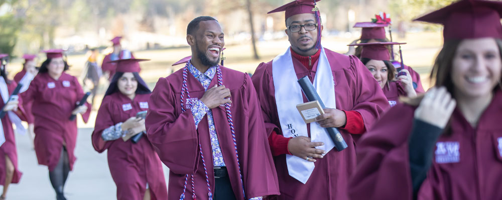 Students in regalia on campus