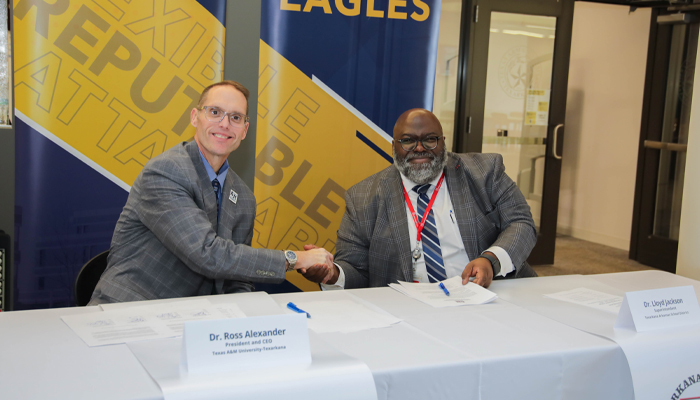 Dr. Ross Alexander and Dr. Lloyd Jackson shaking hands.