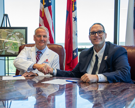 Photo: Texarkana Emergency Center & Hospital Chief Medical Officer Dr. Matt Young (left) and A&M-Texarkana President Dr. Ross Alexander (right) sign a new academic partnership between the center and the university. The new partnership allows qualifying employees of Texarkana Emergency Center & Hospital to take courses at a discounted rate.