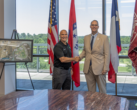 Photo: Steve Smith (left), GPI Texarkana VP & Resident Manager and Dr. Ross Alexander, Texas A&M University-Texarkana President shake hands after forming a partnership between the paper goods manufacturing facility and the university. The new partnership allows qualifying GPI-Texarkana employees to receive discounted tuition for coursework at the university.