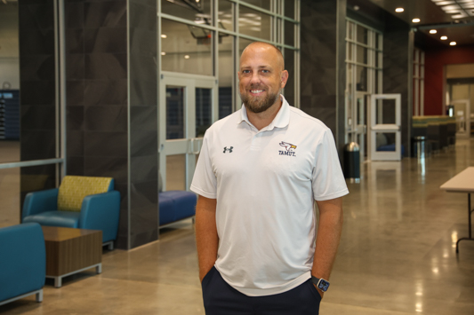 Newly named Director of Athletics Ryan Wall stands in the Lois & Cary Patterson Student Center, home to Eagles basketball, volleyball, cheer, and dance. Wall is in his 6th year with the university, serving as the inaugural coach of the men’s basketball team. Prior to A&M-Texarkana he was the head basketball coach at Our Lady of the Lake University in San Antonio, Texas.